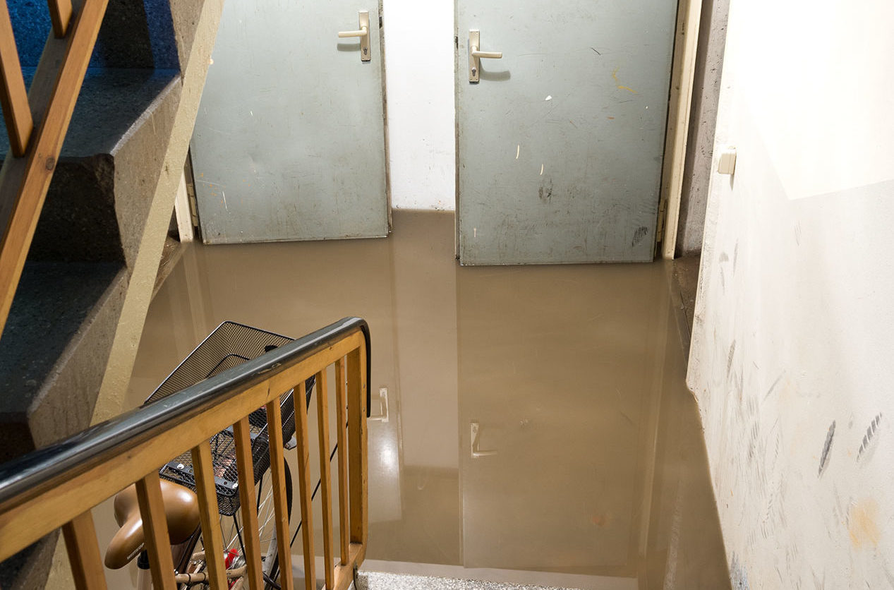 bottom of stairs flooded with dirty water