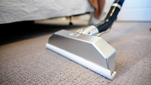 close up on specialized vacuum Deep cleaning carpet in bedroom